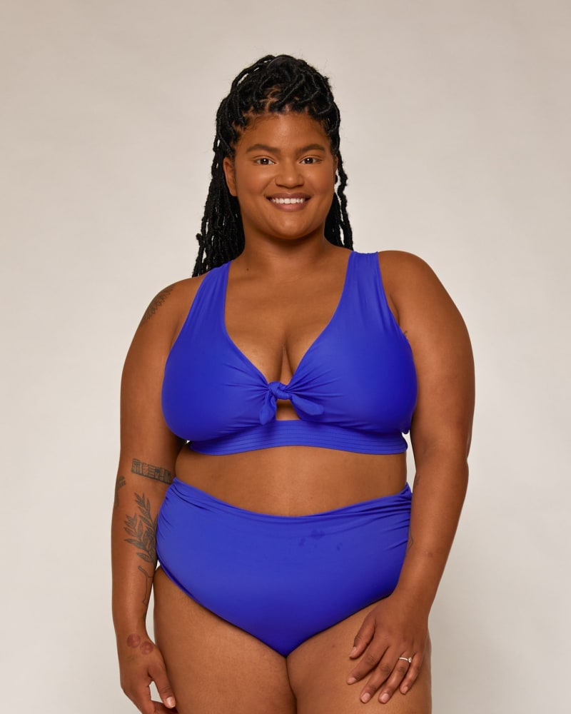 Front of a model wearing a size 1 Dottie Tie Bikini Top in Cobalt by Wild Isles Swim. | dia_product_style_image_id:284948